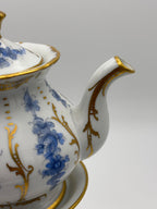 Tisanière sur réchaud (ou chauffe théière)en porcelaine à décore floral bleu et rehauts or