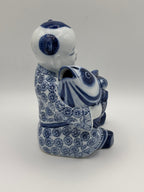 Statuette enfant au poisson en porcelaine