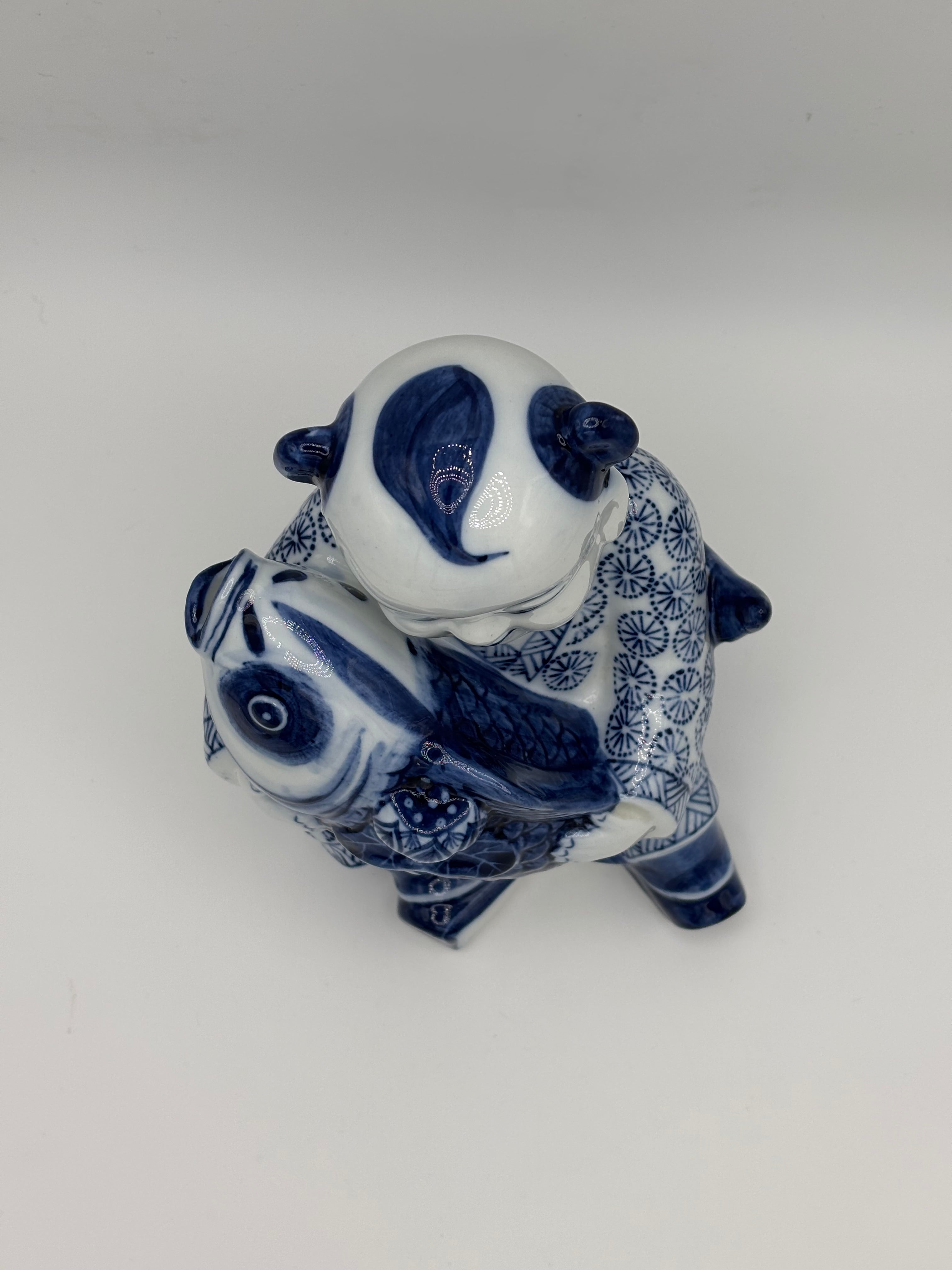 Statuette enfant au poisson en porcelaine